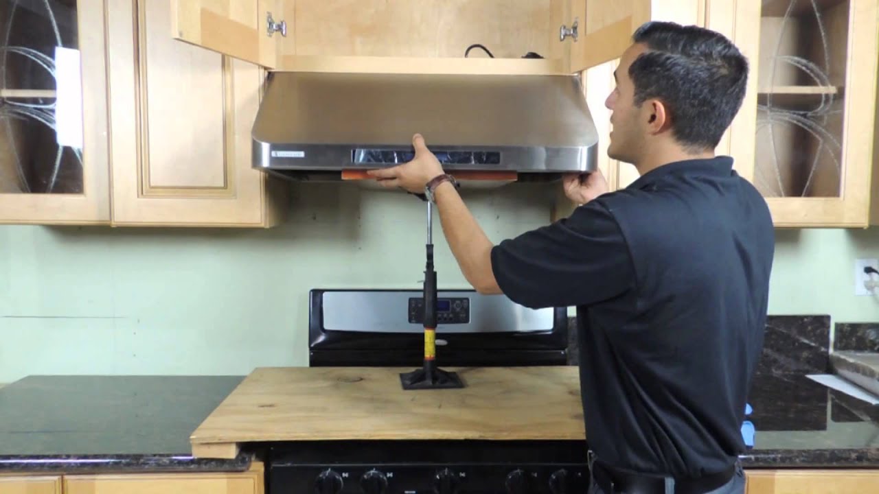 Kitchen hood installer working on commercial extraction system in Manchester