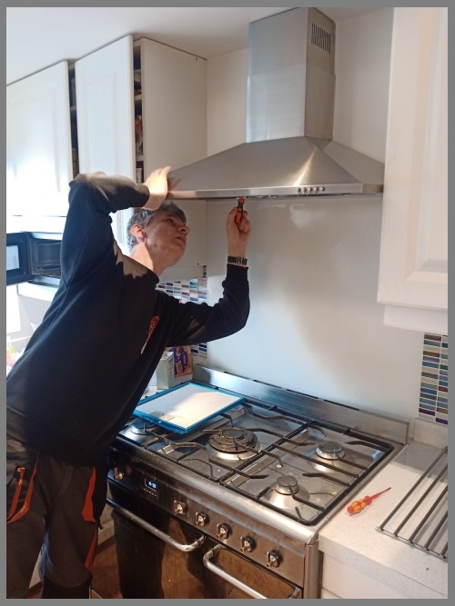 Kitchen hood installer in Manchester working safely on commercial ventilation